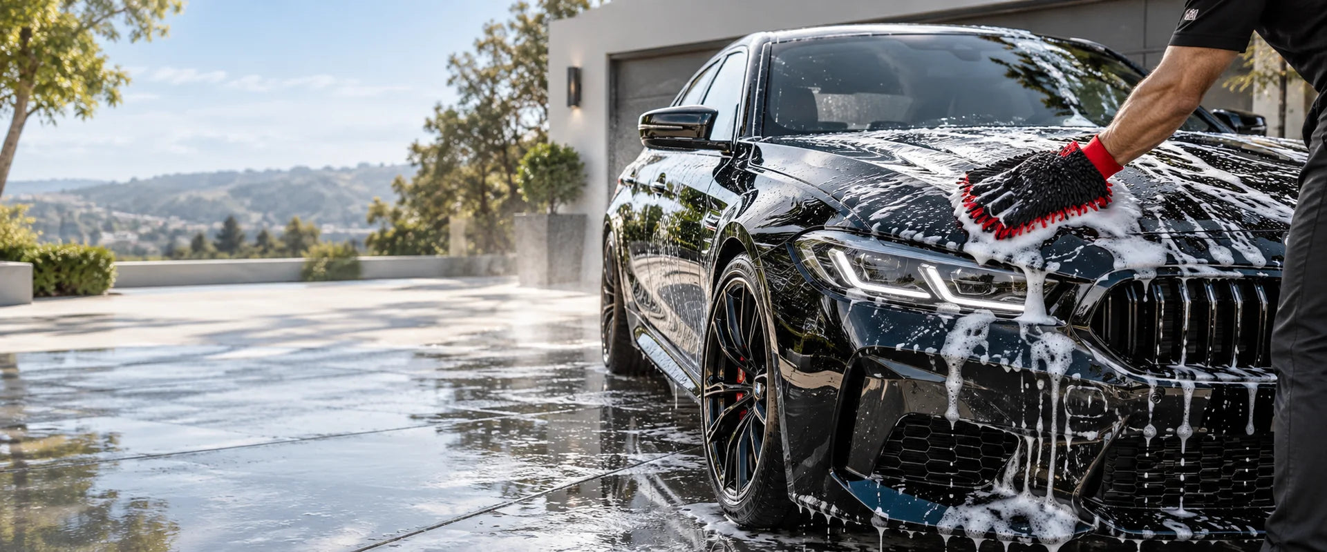 Black car being washed with a microfiber mitt